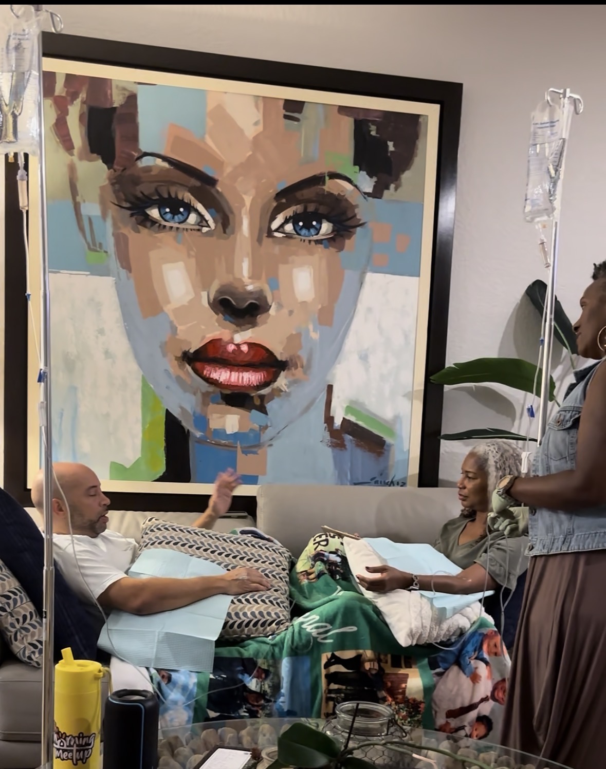 A small group of IVybe clients receiving drip therapy together in a relaxed home setting